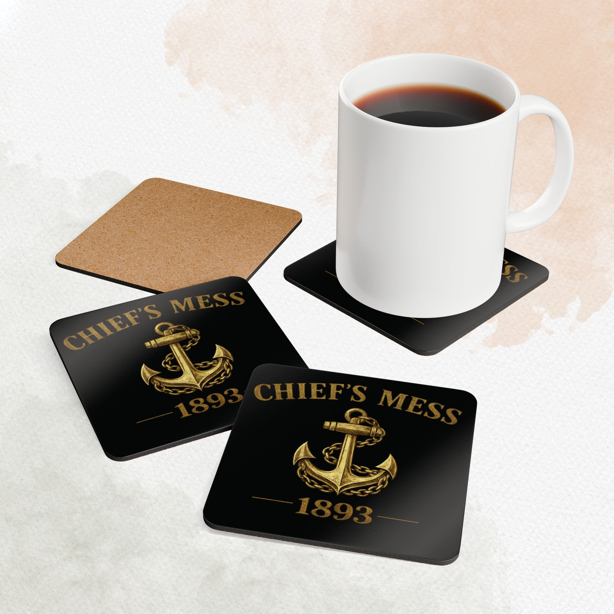 Coasters with 'Chief's Mess 1893' design on a white surface with a mug of coffee.