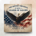 Decorative clock with an eagle and American flag design, featuring text about being a leader of sailors.