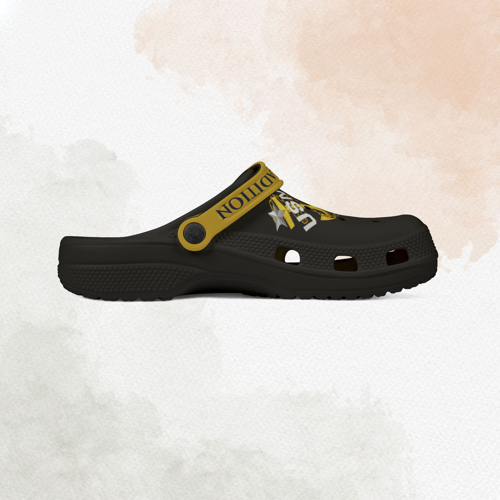 Black clog shoe with yellow strap on a white background