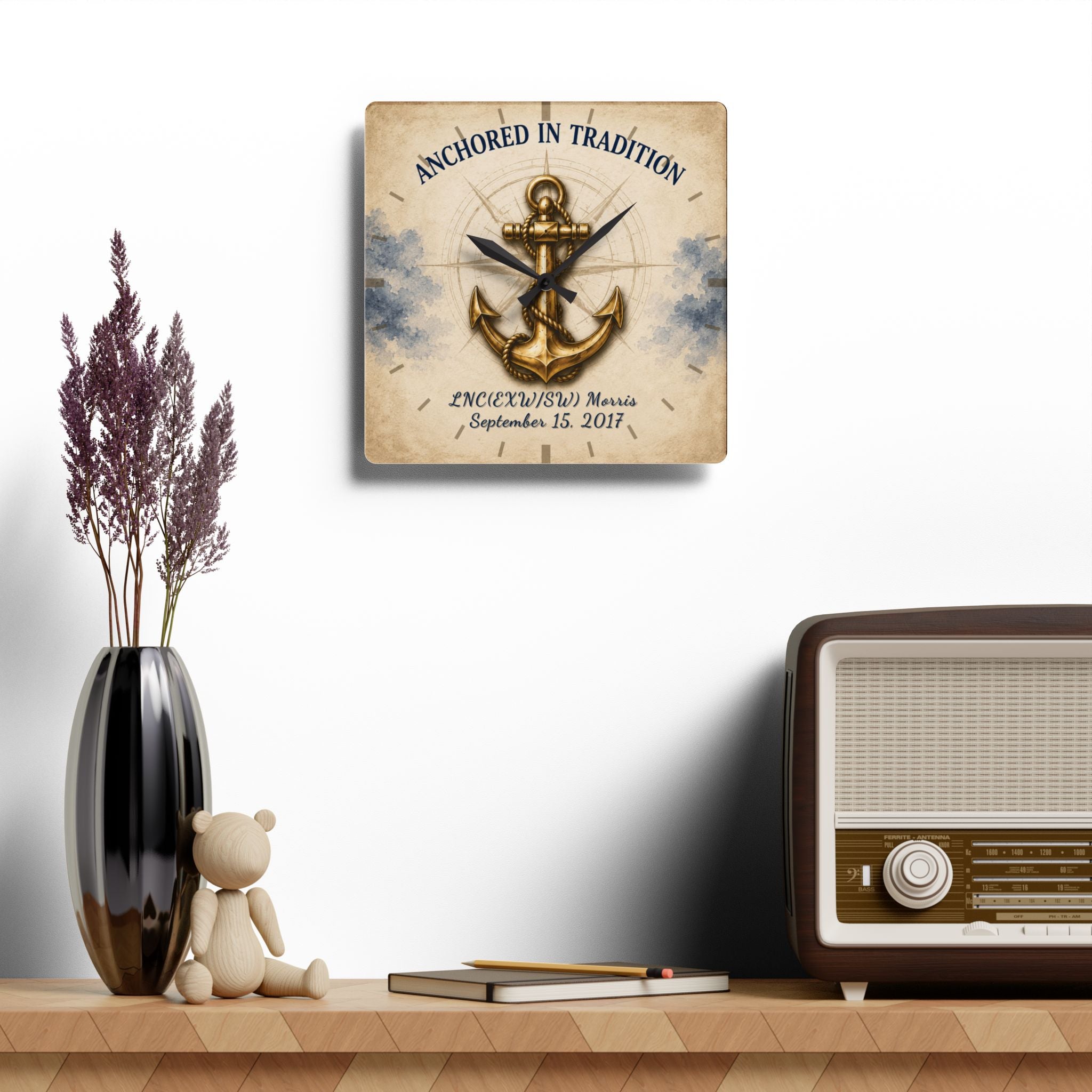 Decorative wall clock with anchor design on a shelf with a vase, teddy bear, and radio.