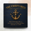 Decorative clock with anchor design and text on a dark blue background
