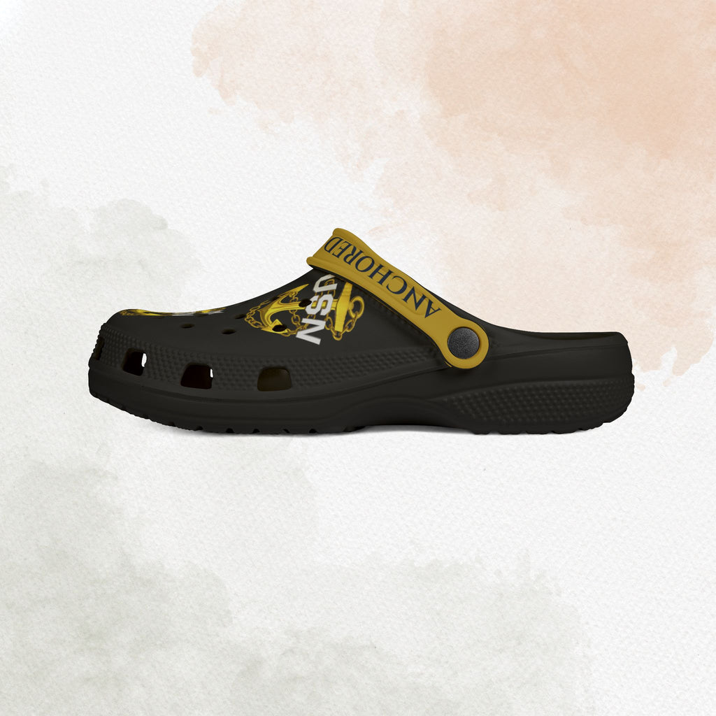 Black clog shoe with yellow strap and text on a light background
