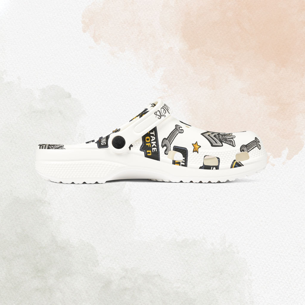 White clog shoe with black graphics on a white background