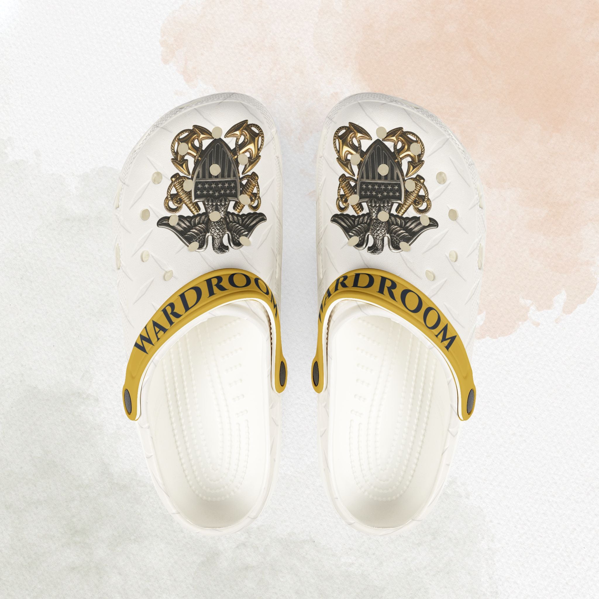 White clogs with gold and black design on a light background
