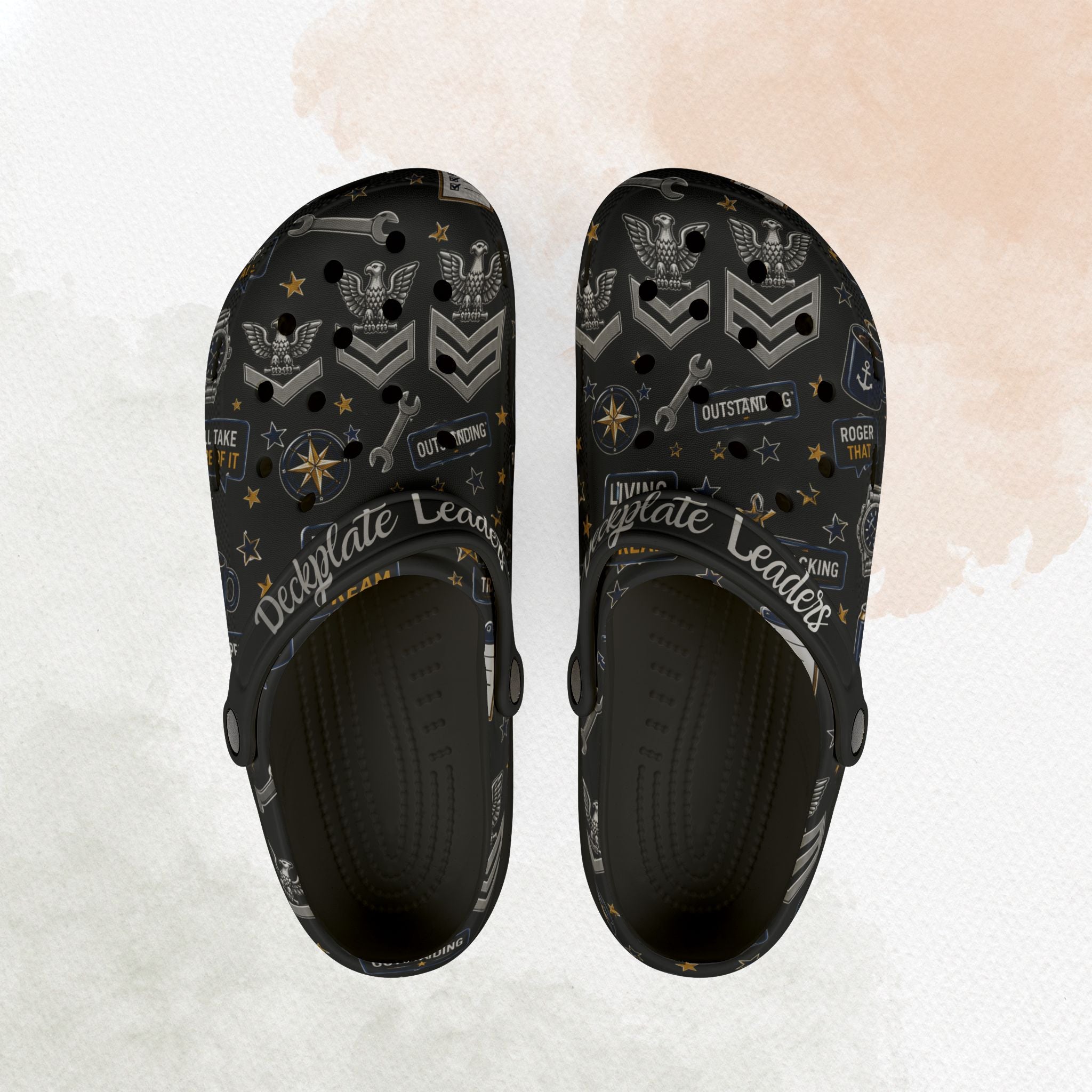 Black clogs with decorative patterns on a textured white background