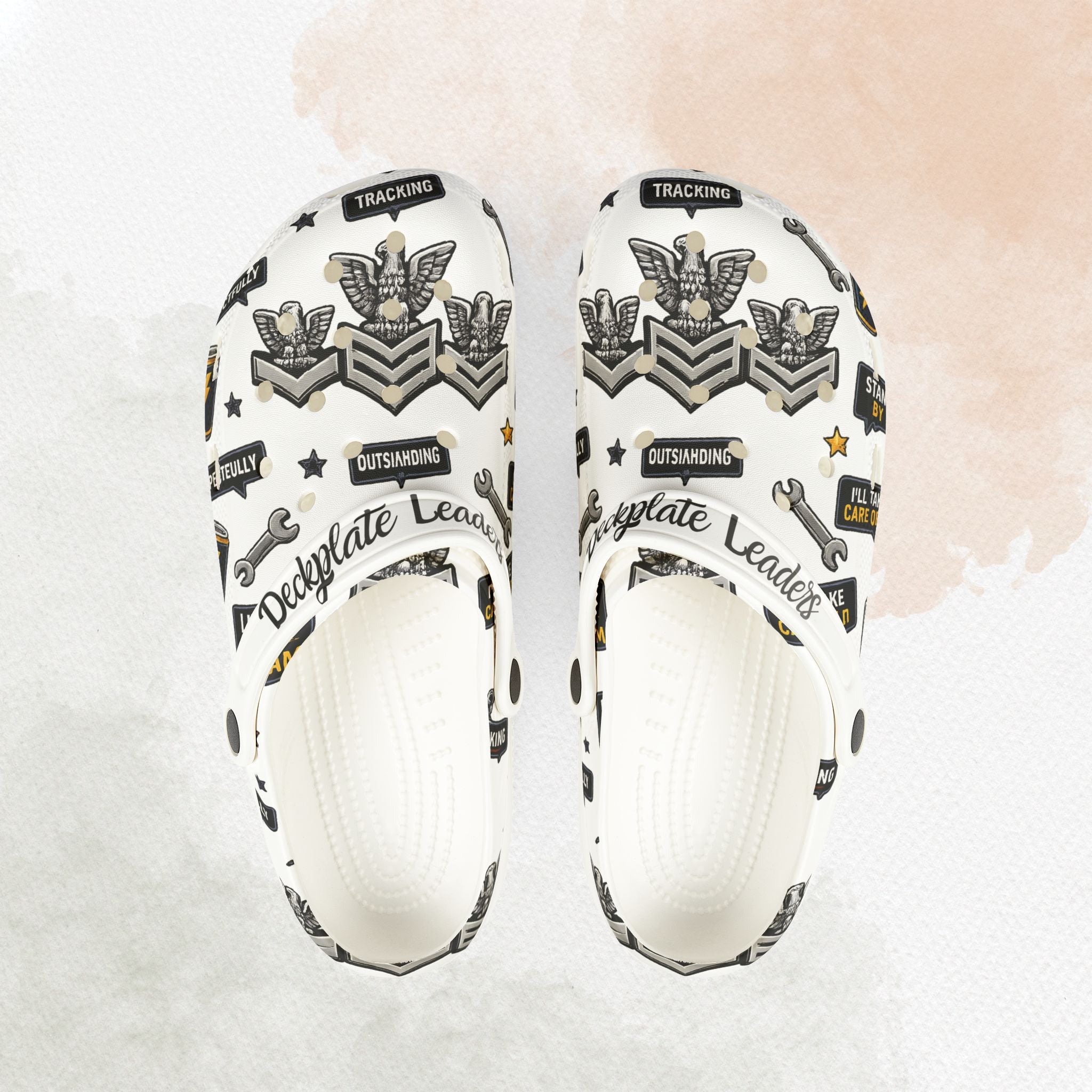 White slide sandals with black and gold design on a light background
