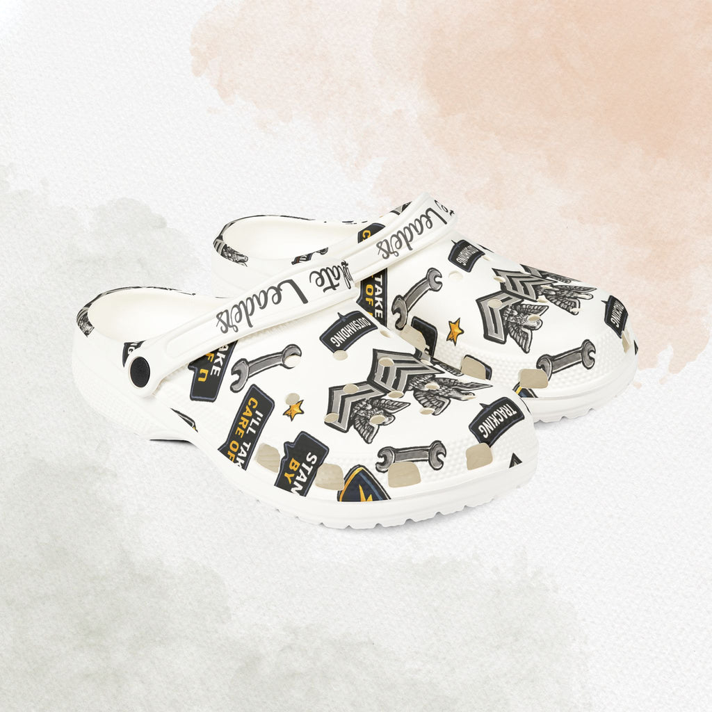 White sneakers with black graphic designs on a light background
