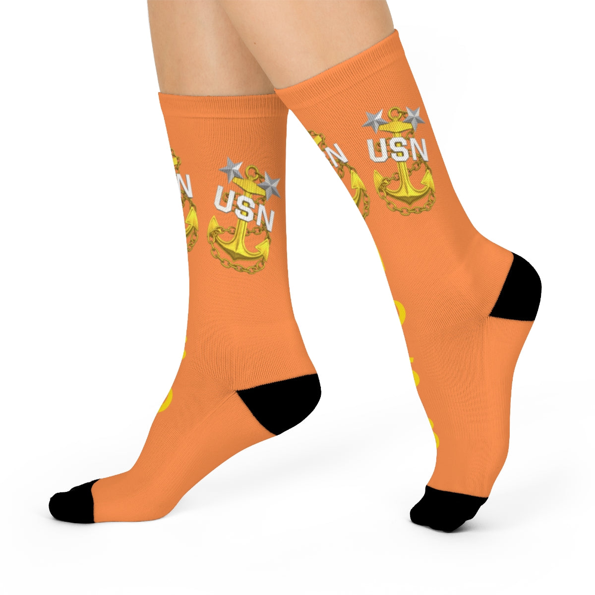 Orange socks with USN logo worn by a person on a white background