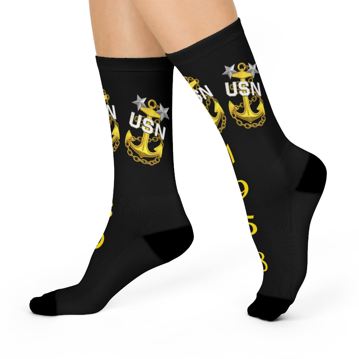 Black socks with yellow USN anchor design on a white background
