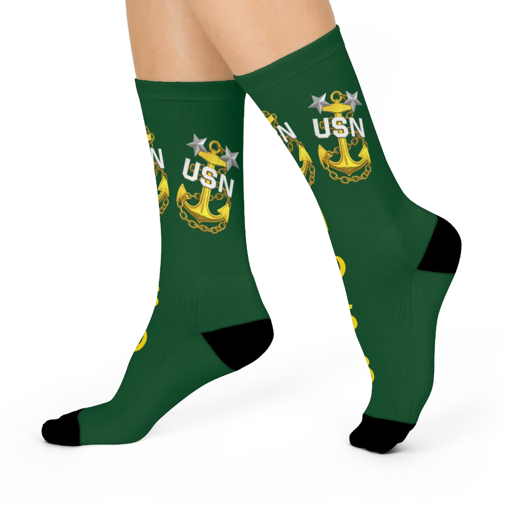 Black socks with yellow USN anchor design on a white background