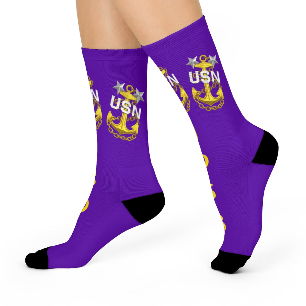 Purple socks with USN logo worn by a person on a white background