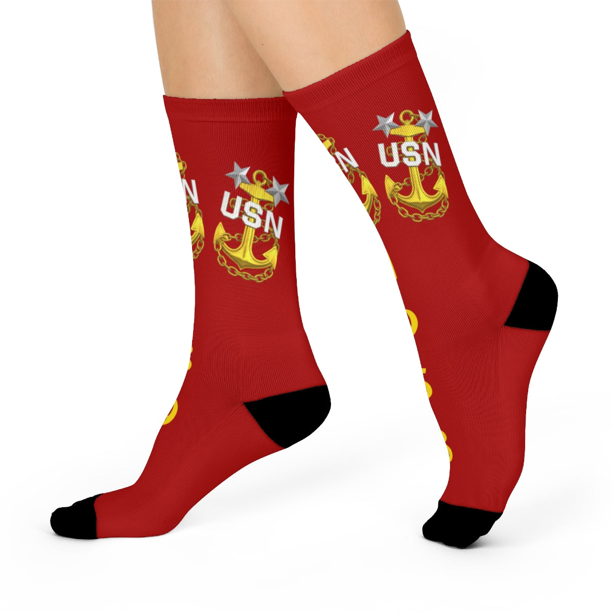 Red socks with USN logo worn by a person on a white background